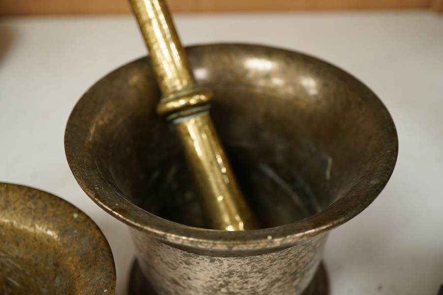 A bronze pestle and mortar, and one other mortar decorated in relief, 18cm in length